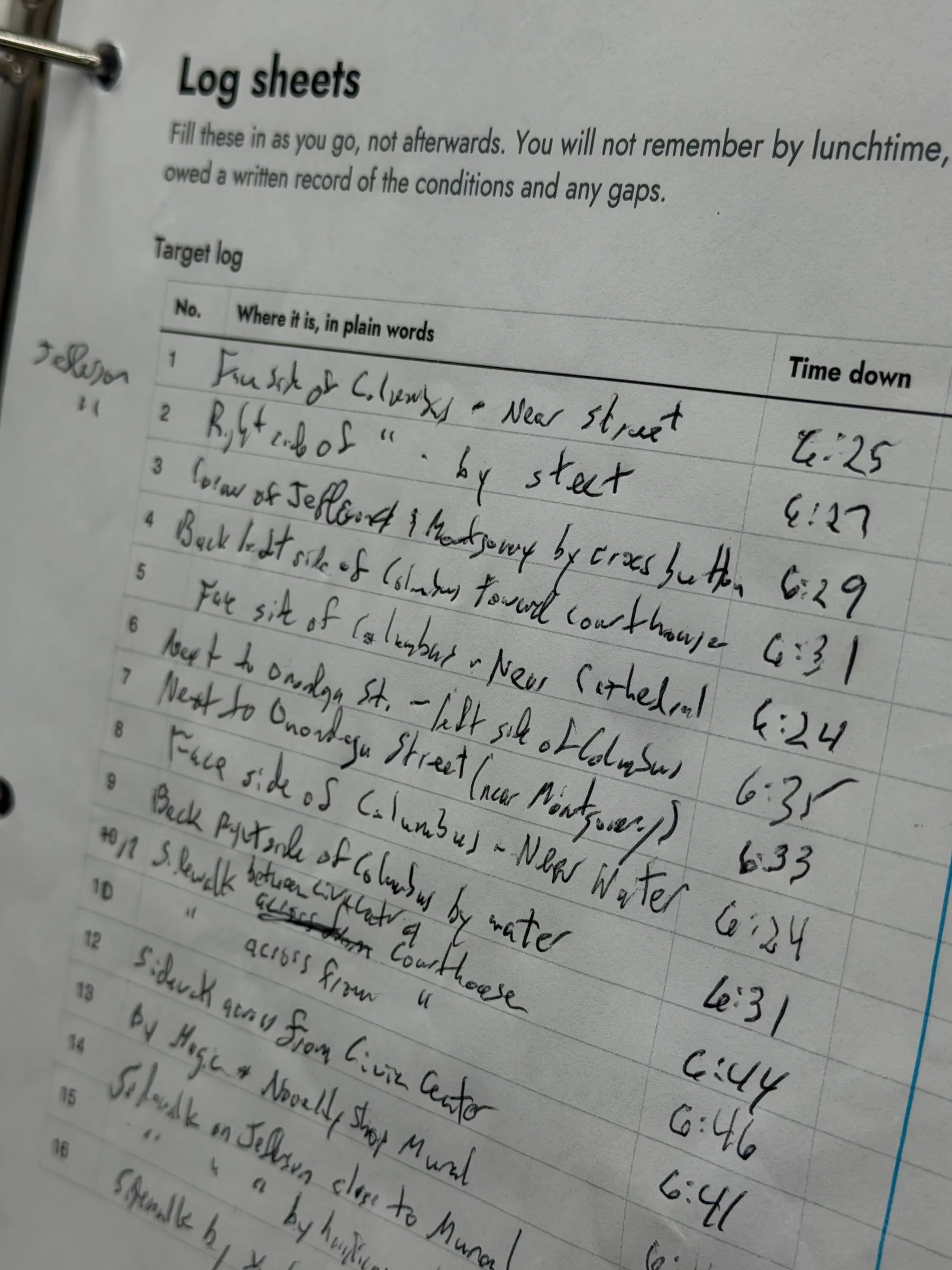 A printed log sheet in a binder with a handwritten target log listing where each marker sits and the time it went down